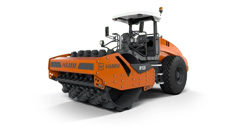 Orange HAMM M12i compactor with spiked roller wheels.